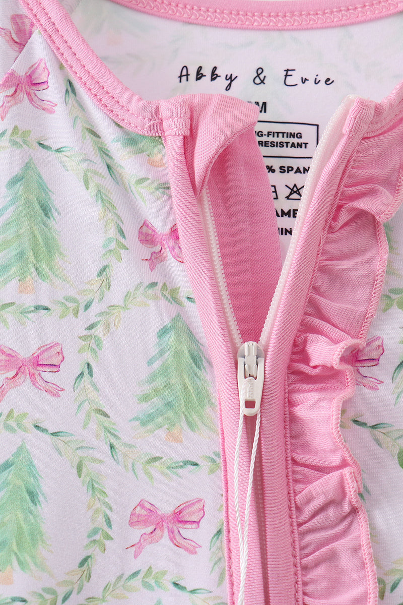 Close-up of a pink baby romper with floral and bow pattern, brand 'Abby & Eriv' visible.