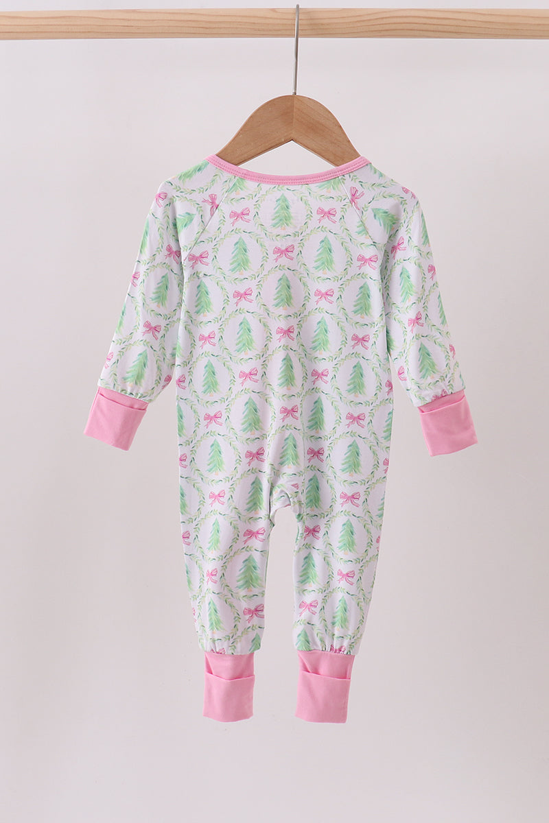 Children's onesie with cactus and bow pattern on a hanger against a white background