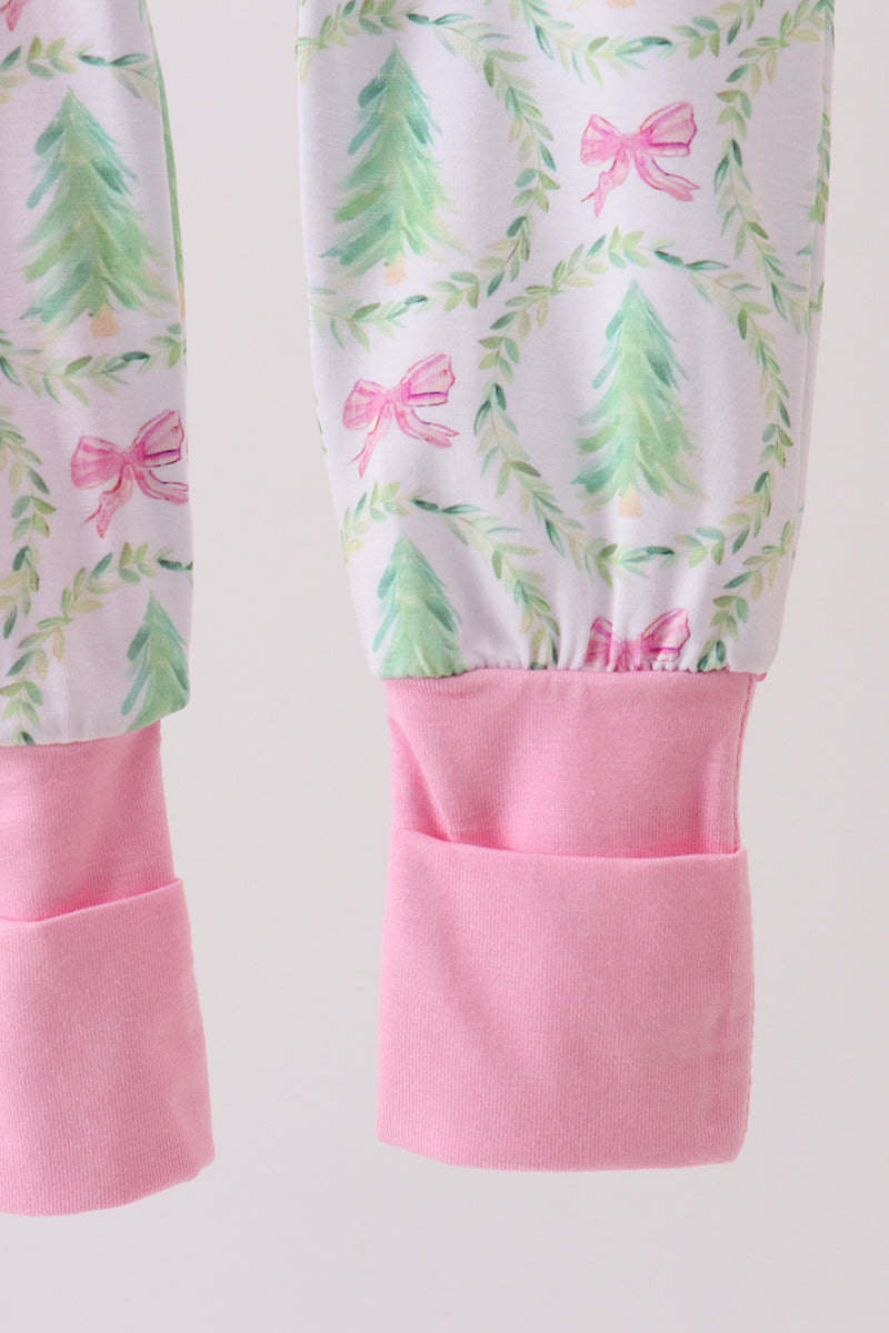 Children's leggings with pink bows and green leaves on a white background