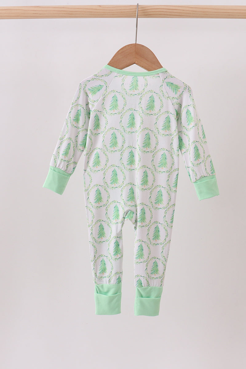 Baby onesie with green dinosaur pattern on a hanger against a white background