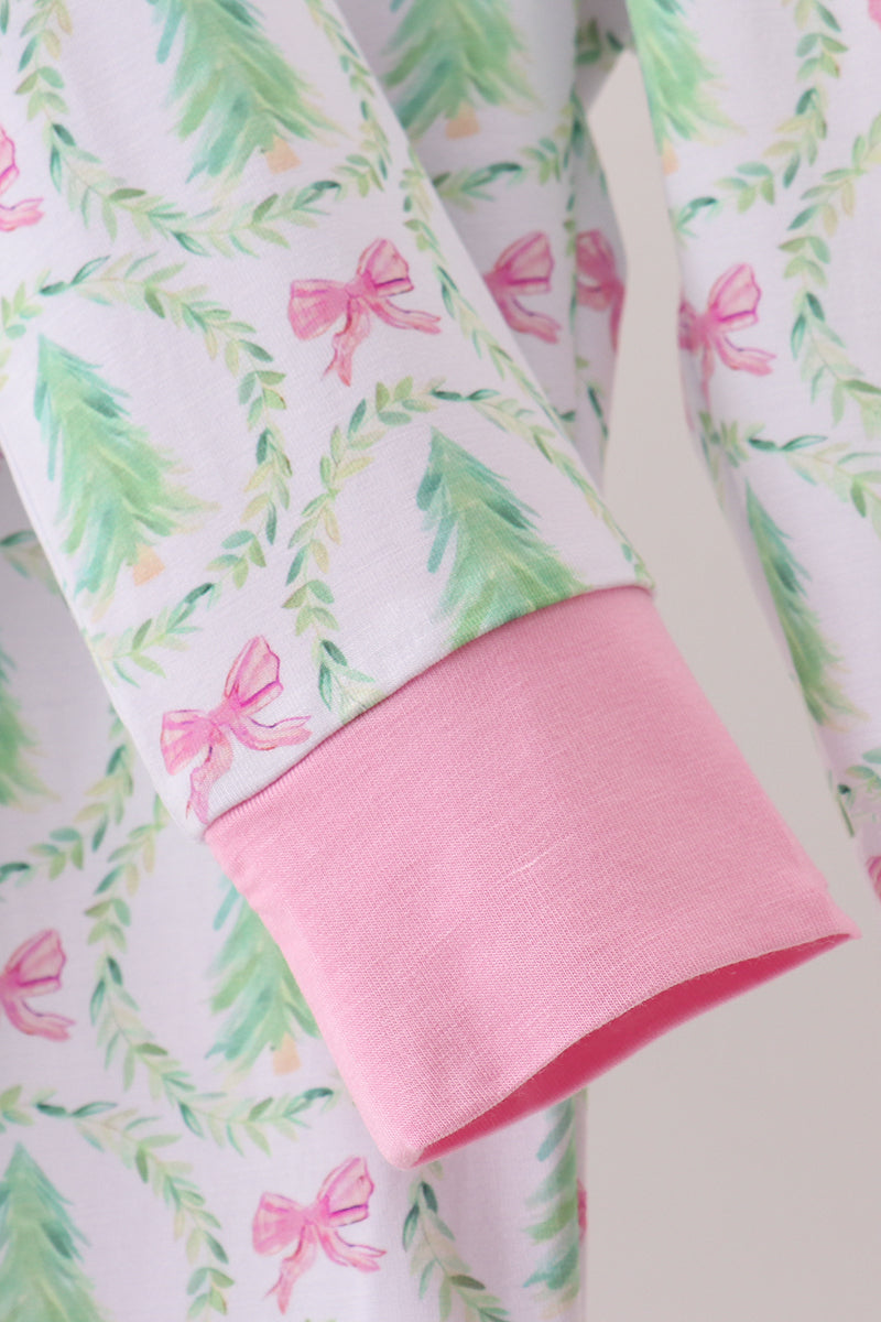 Fabric with pink bows and green leaves on a white background