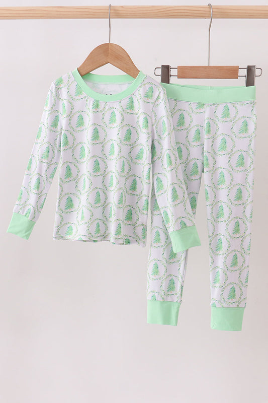 Children's pajama set with green and white pattern on a hanger against a white background