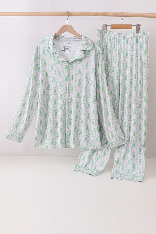 Green and white patterned pajama set on hangers against a white background