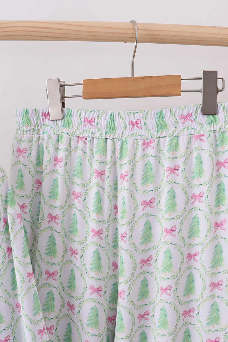 Skirt with tree and bow pattern hanging on a wooden hanger against a white background