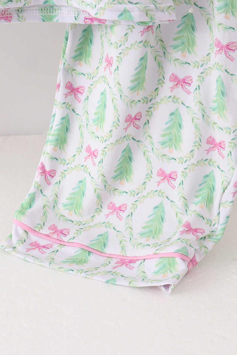 Baby romper with green leaf and pink bow pattern on a white background
