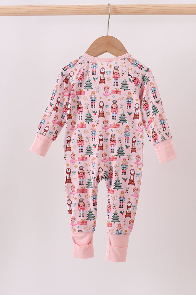 Baby onesie with Christmas pattern on a hanger against a white background