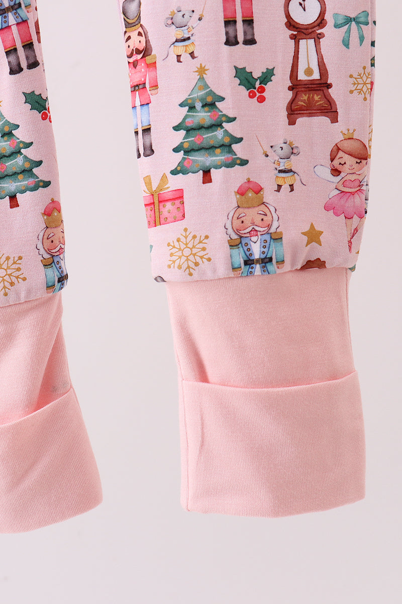 Children's leggings with Christmas-themed design on a light pink background