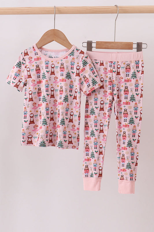Children's pajama set with Christmas pattern on a hanger against a light background