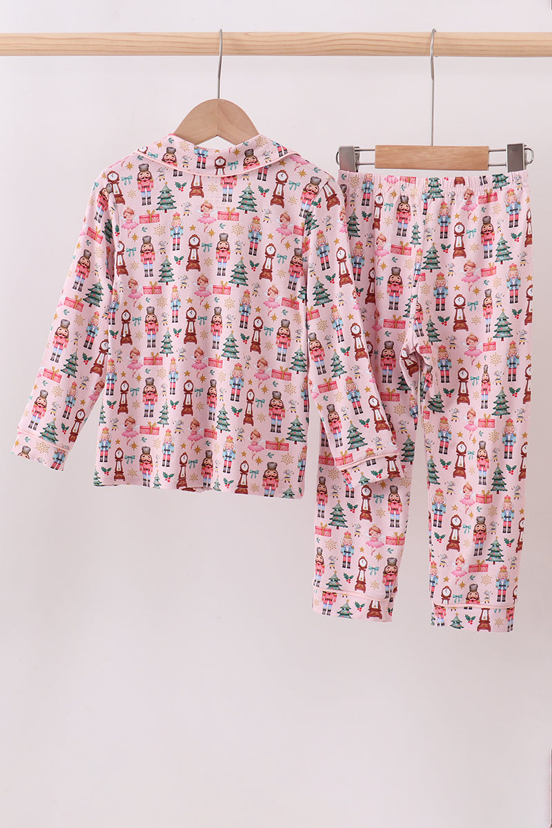 Children's pajama set with Christmas pattern on a hanger against a white background