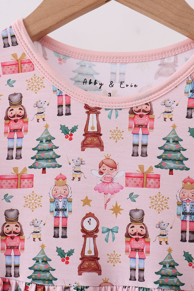 Children's outfit with Christmas-themed pattern on a hanger