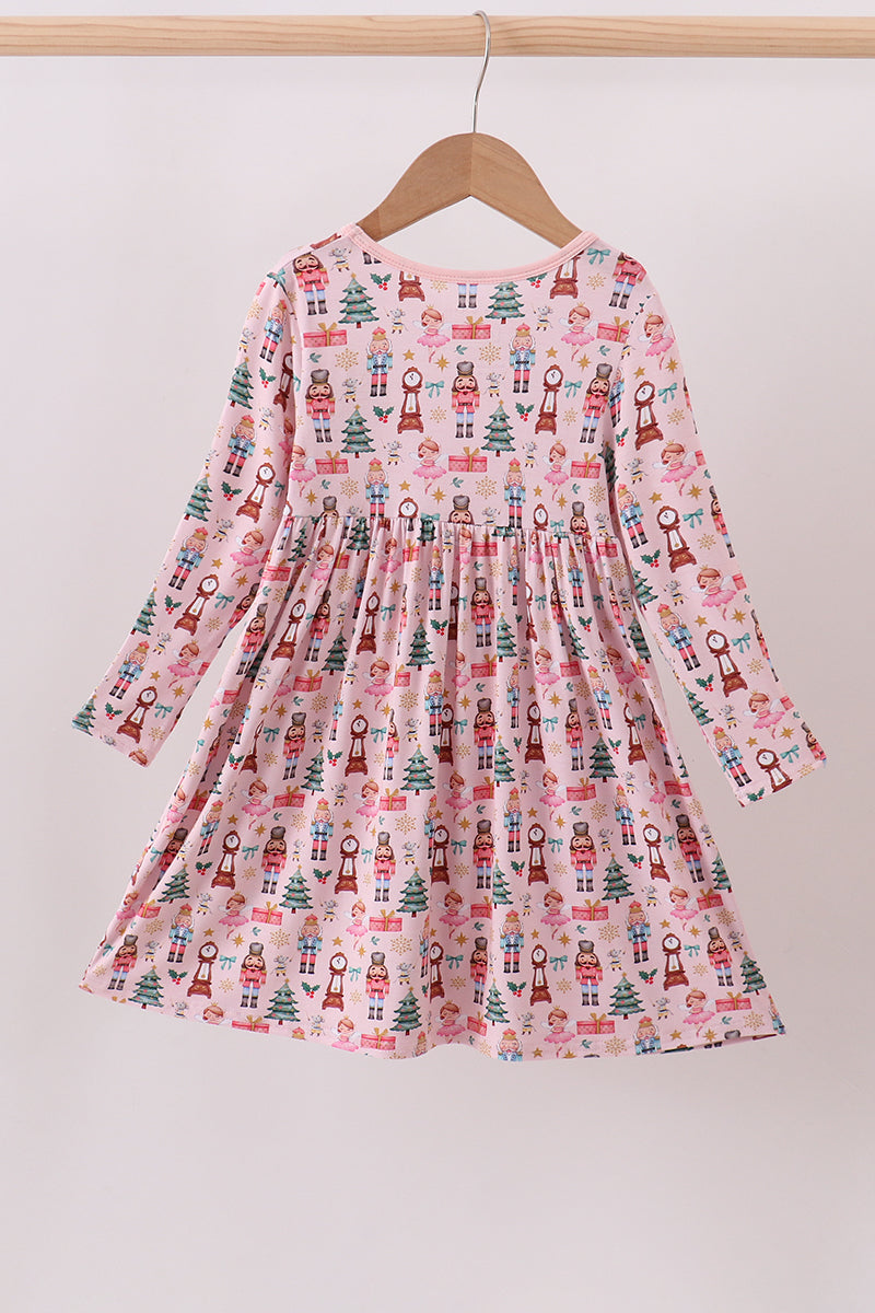 Children's dress with festive pattern on a hanger against a white background
