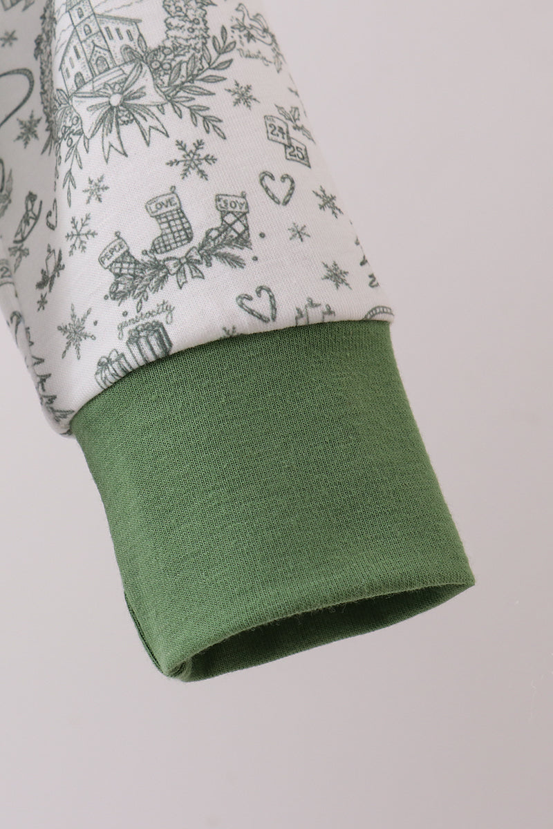 Close-up of a green fabric edge with a patterned fabric background