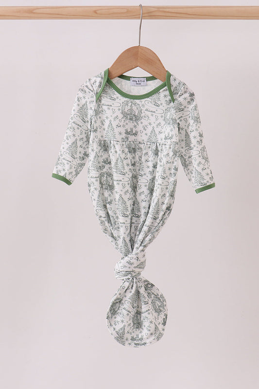 Baby outfit with green floral pattern on a hanger against a light background