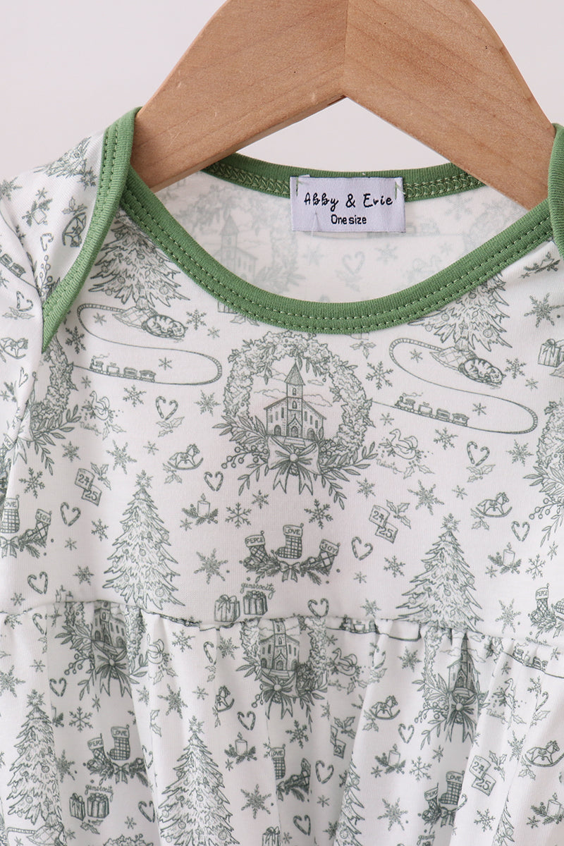 Baby dress with green trim and a pattern of trees, houses, and hearts on a hanger.