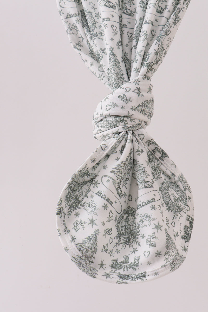 Fabric with a pattern of small illustrations tied into a knot on a light gray background