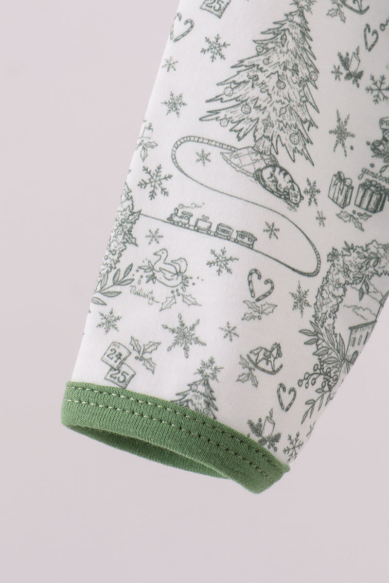 Folded towel with Christmas-themed design on a light pink background