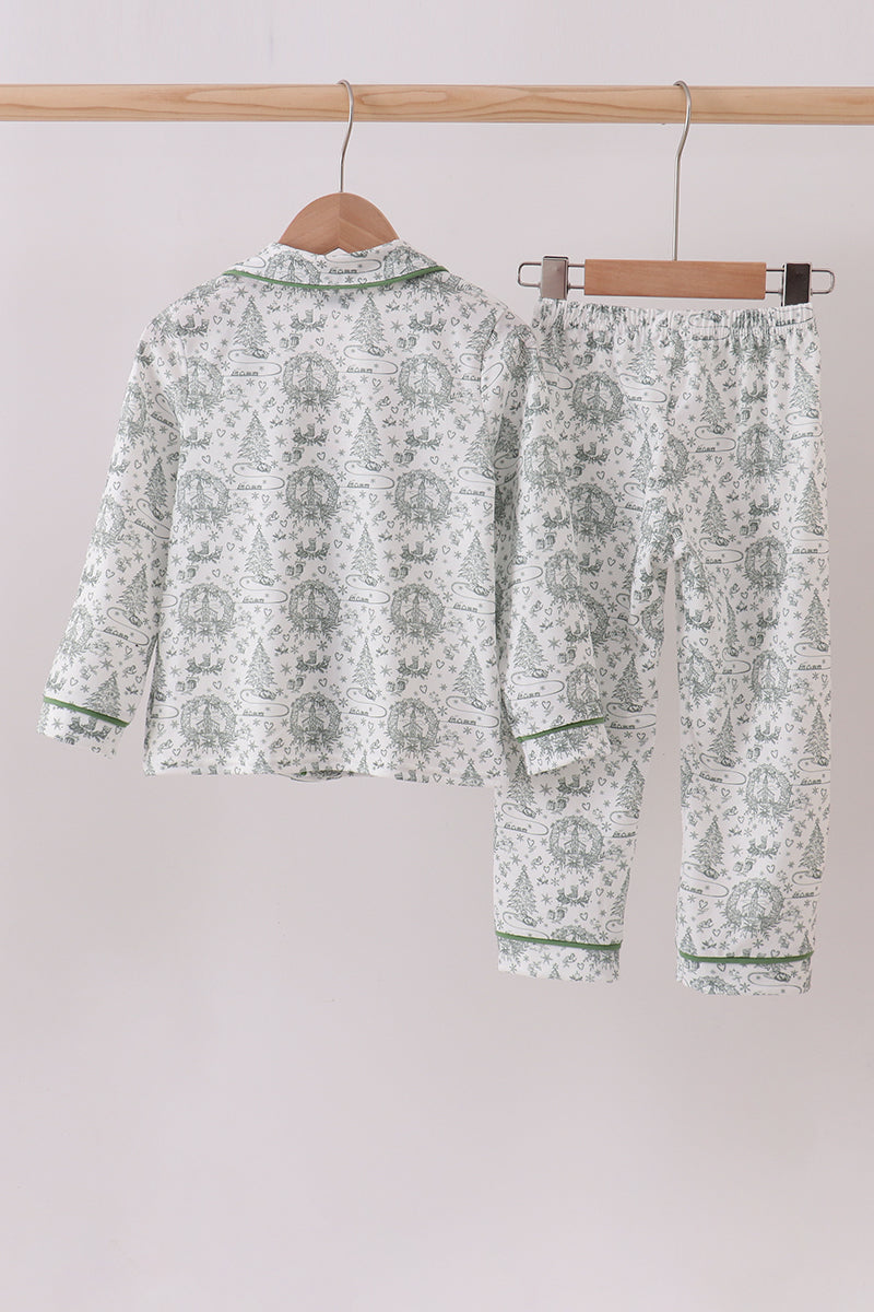 Floral pajama set hanging on a wooden rod against a light background