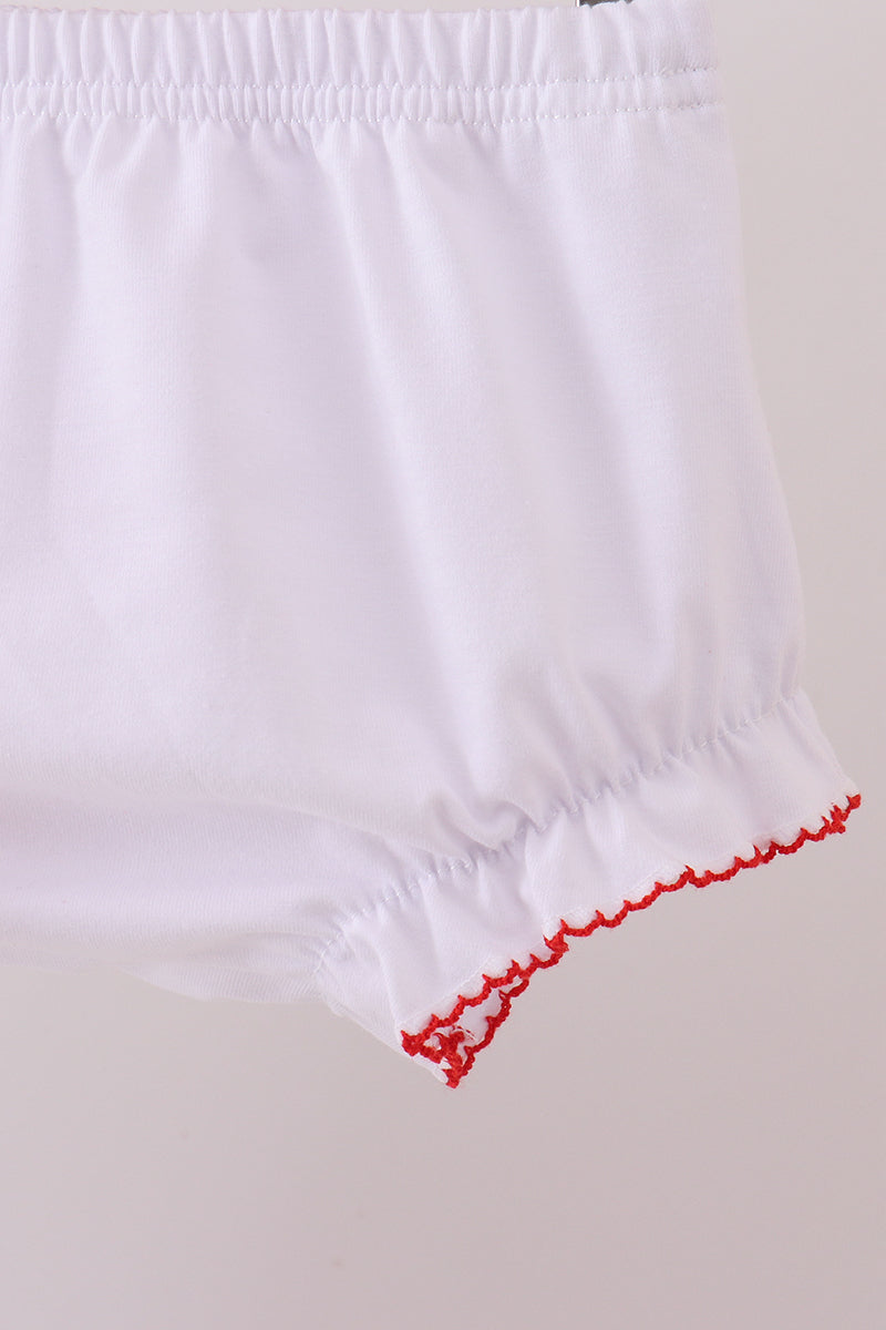 White fabric with red trim on a plain background