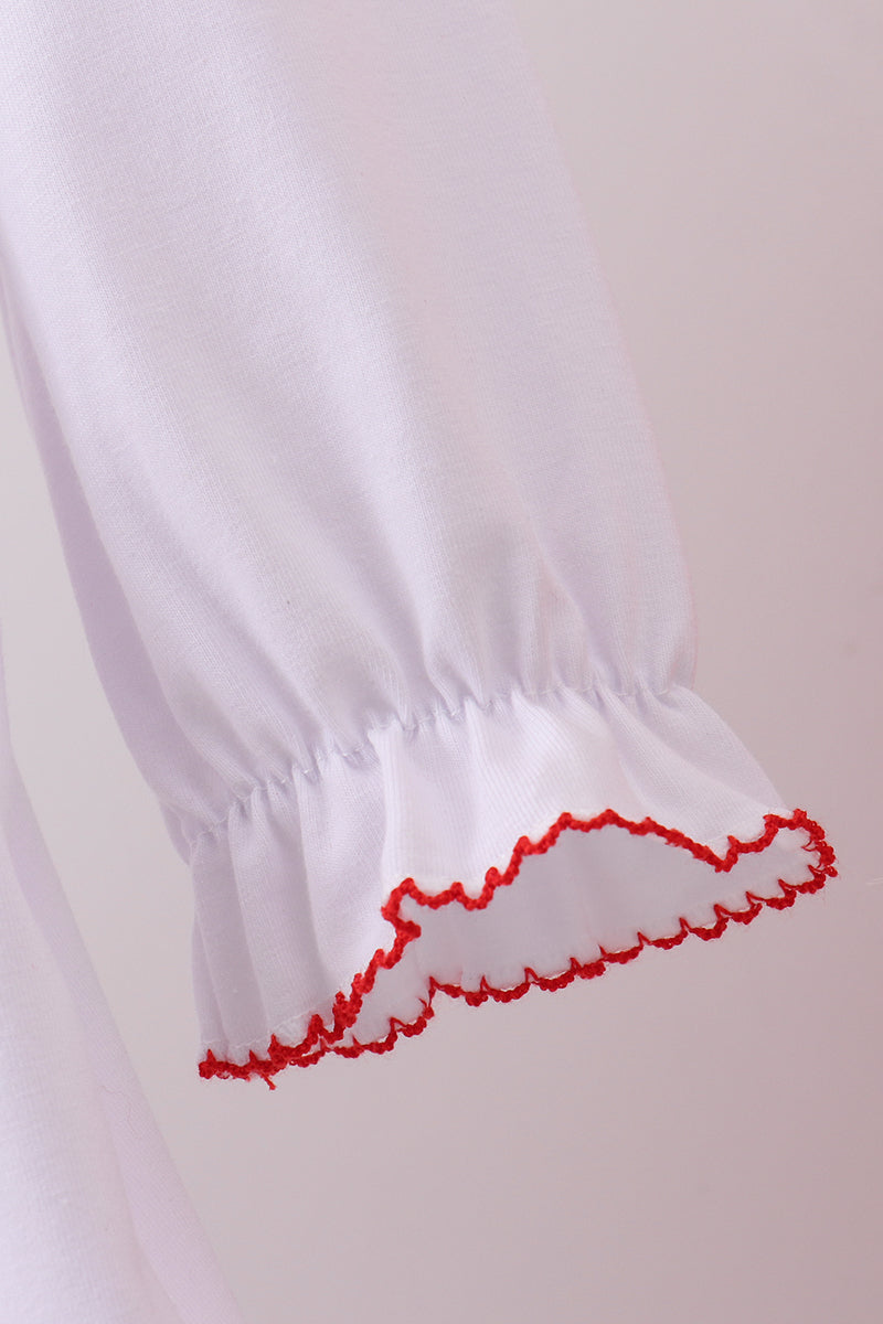 White garment with red trim on a plain background