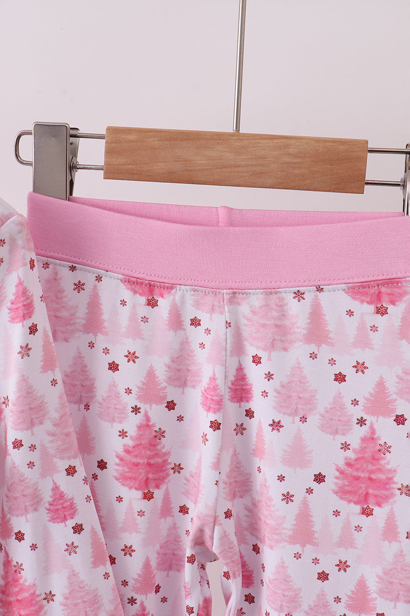 Pink and white skirt with tree pattern on a hanger against a white background