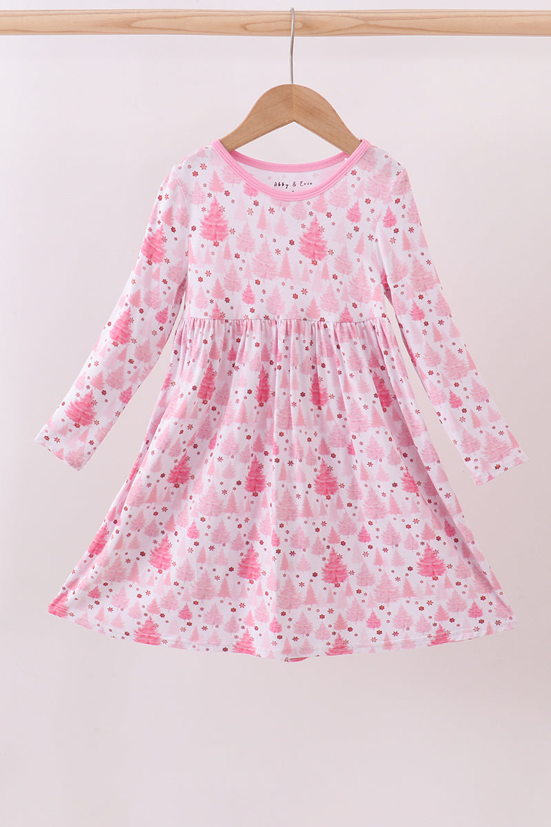 Pink children's dress with floral pattern on a hanger against a white background