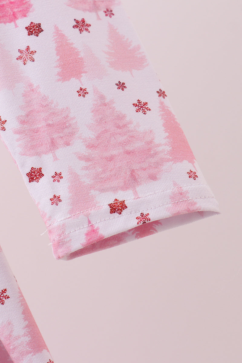 Pink fabric with red floral patterns on a light pink background