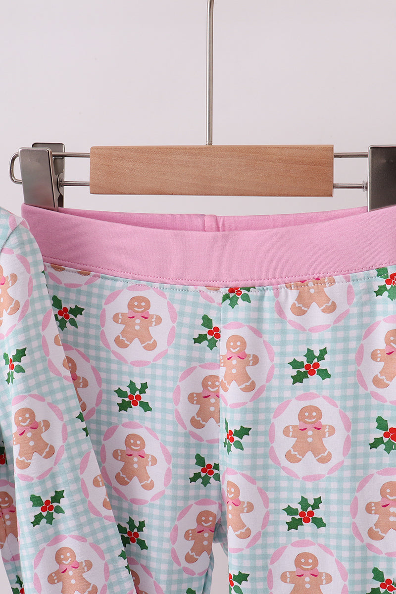 Skirt with gingerbread man pattern on a hanger against a white background