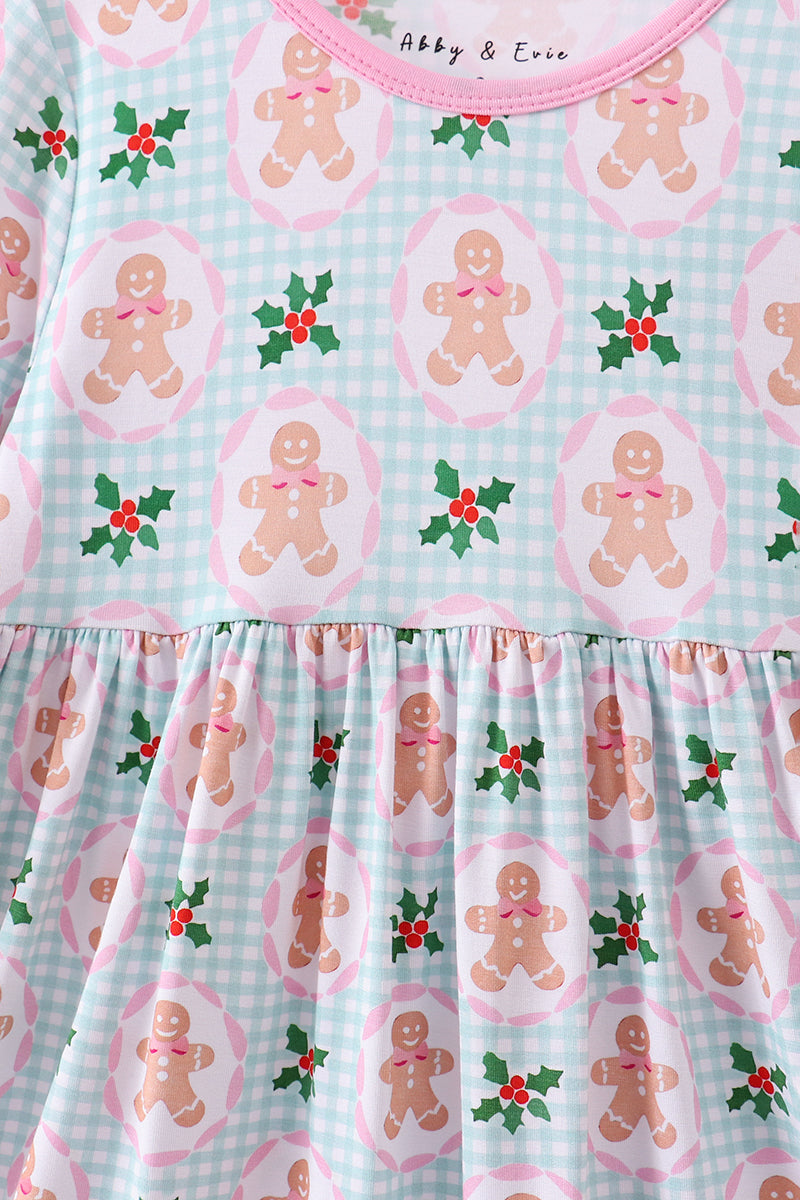 Children's dress with gingerbread man and holly pattern on a checkered background