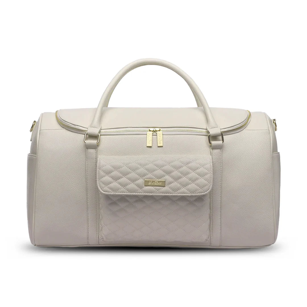 Light gray quilted duffel bag with gold accents on a white background