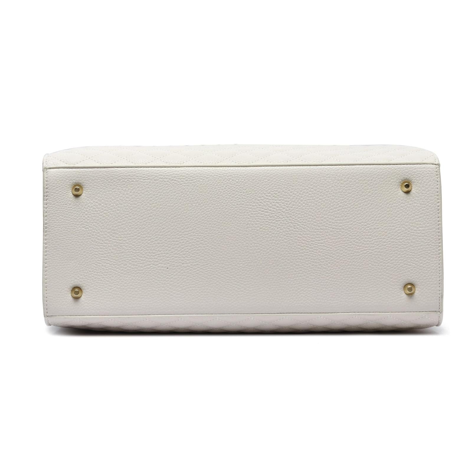 White handbag with gold hardware on a white background
