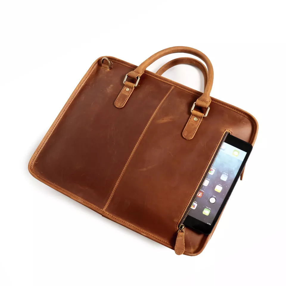 Brown leather briefcase with a smartphone inside on a white background