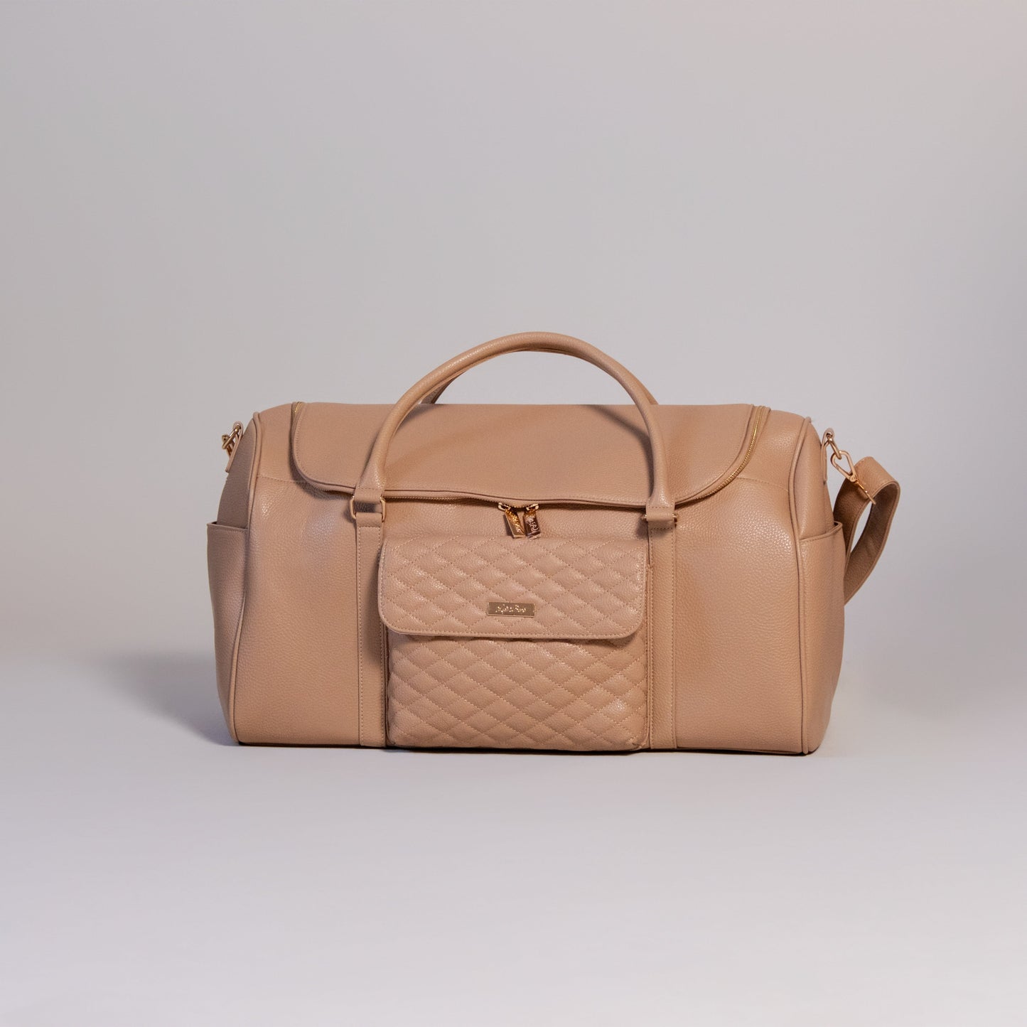 Beige duffel bag with quilted section on a light gray background