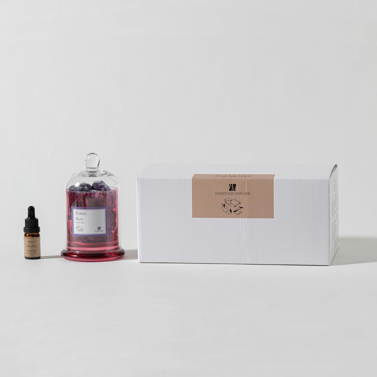 Bottle with dropper, glass container with berries, and box on a light gray background