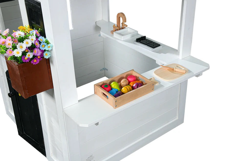 Children's play kitchen set with toys and a flower box on a white background