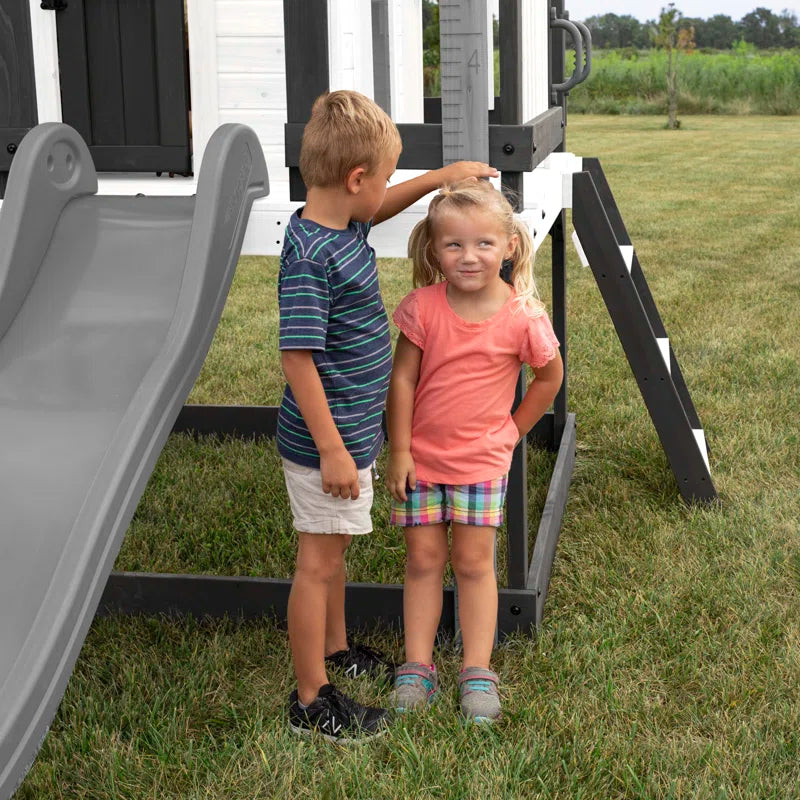 Sweetwater Heights White Cedar Wooden Elevated Kids Playhouse with Wave Slide, Play Kitchen, and Deck