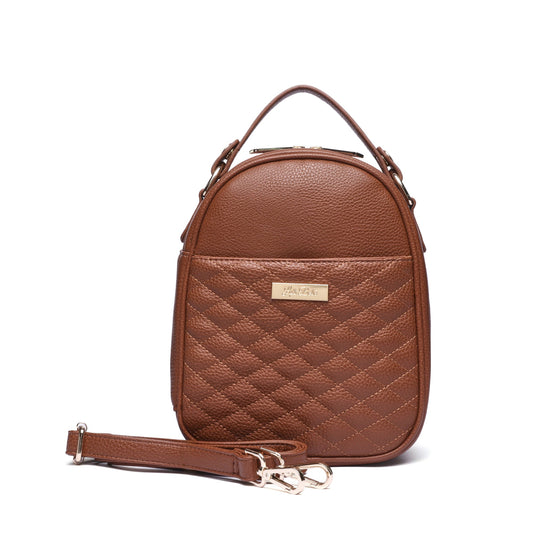A caramel brown quilted mini bag with a zipper and a detachable strap, displayed against a white background.