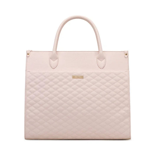 Quilted light pink handbag on a white background
