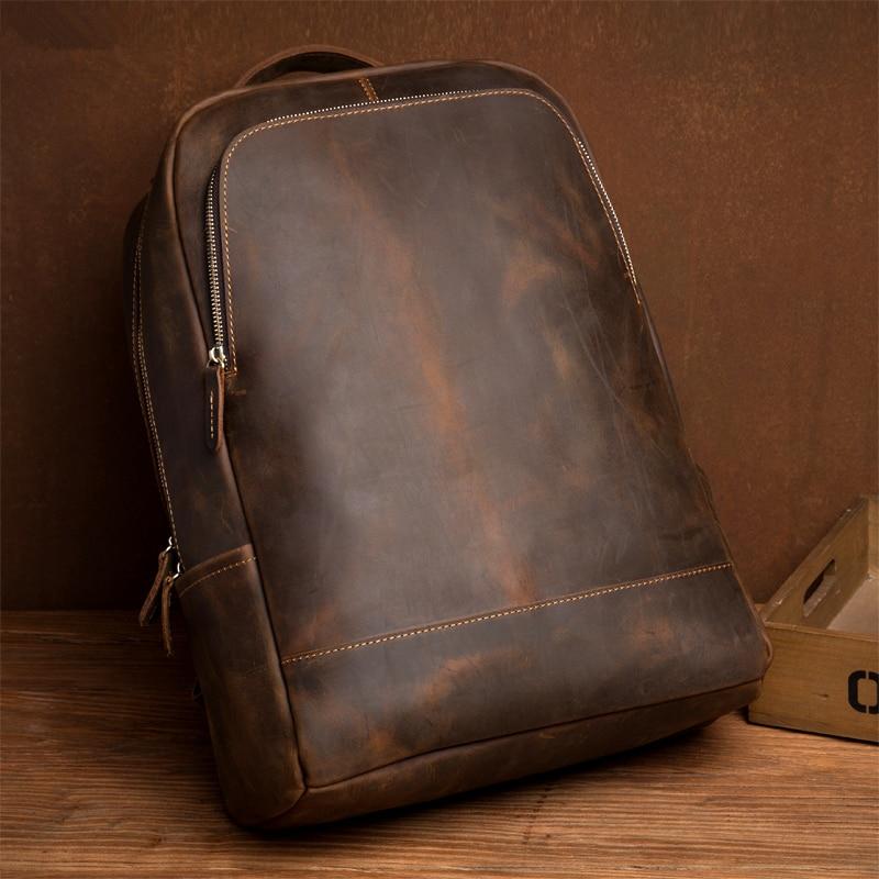 Brown leather backpack on a wooden surface with a brown background