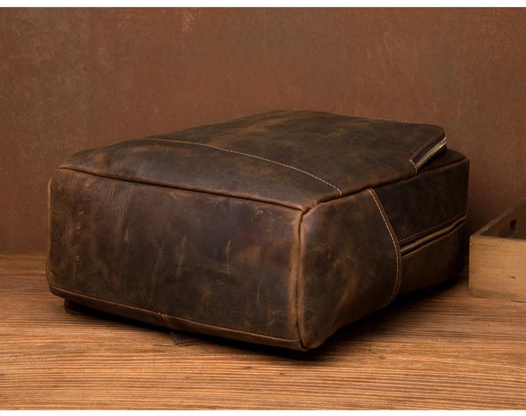 Brown leather ottoman on a wooden surface with a brown background