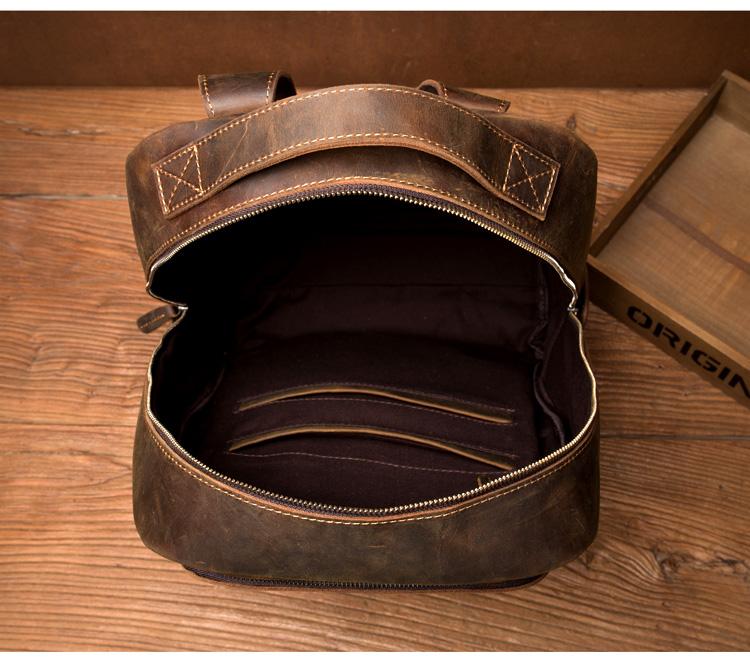 Brown leather bag with visible stitching on a wooden surface